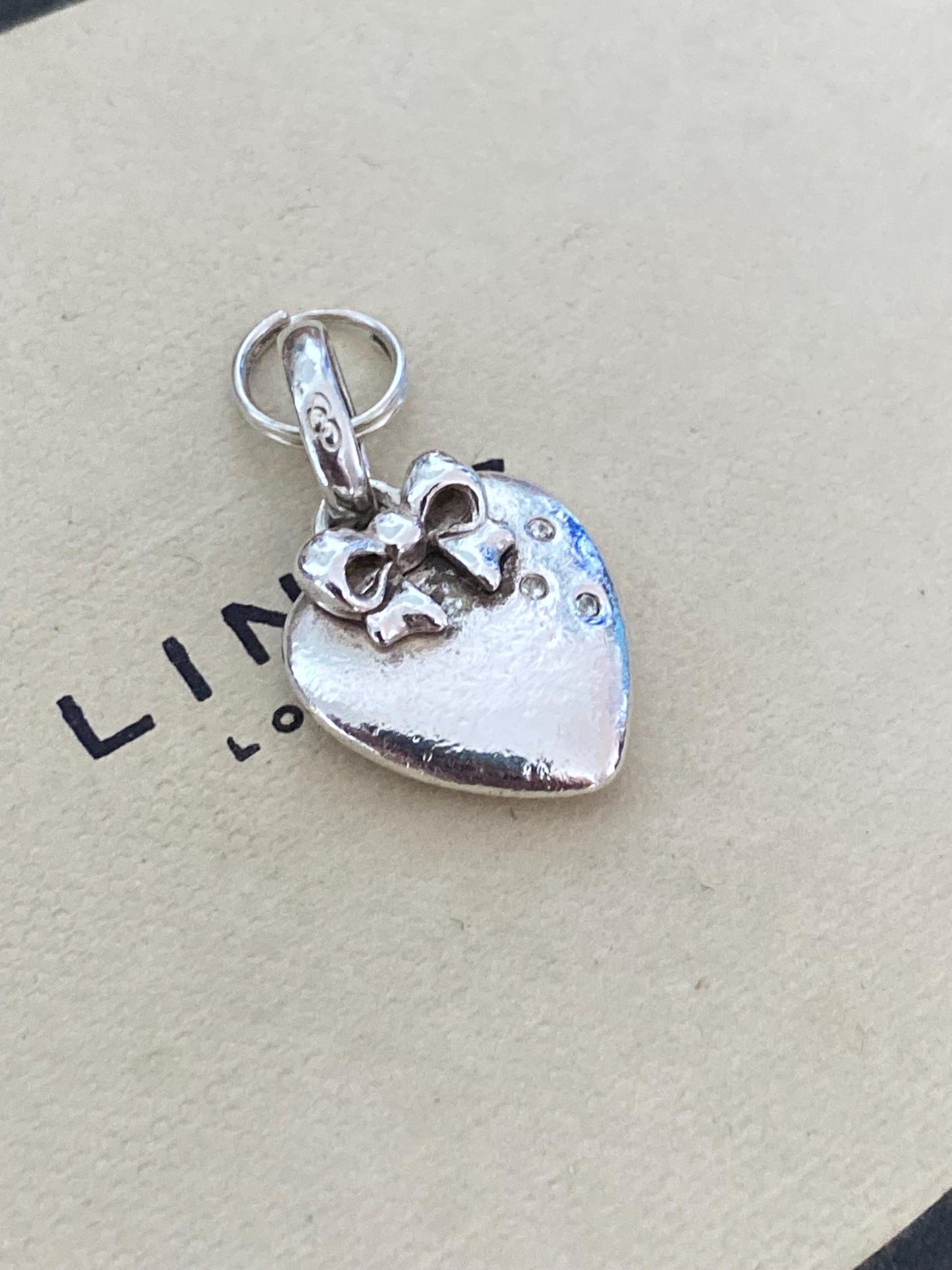 Beautiful genuine rare hallmarked Links of London sterling silver heart charm with bow and topaz stones